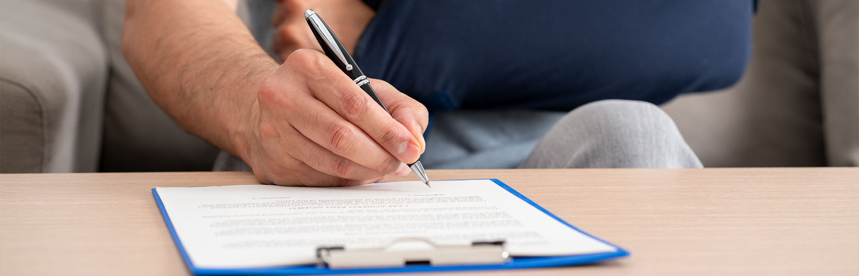 An injured man filling out a personal injury form.