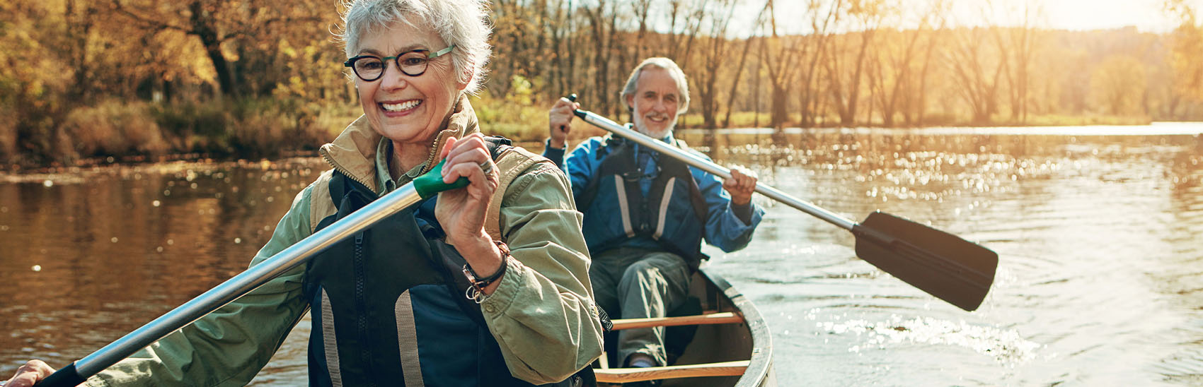 Happy couple canoeing in a lake