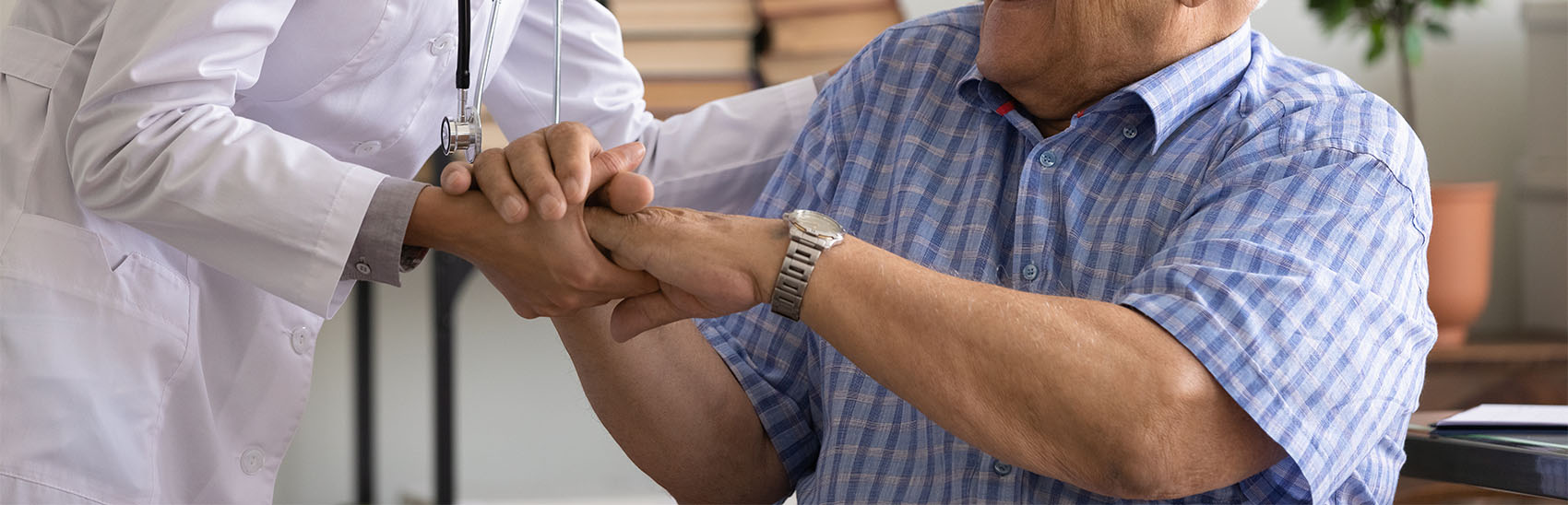 Doctor and patient holding hands with trust.