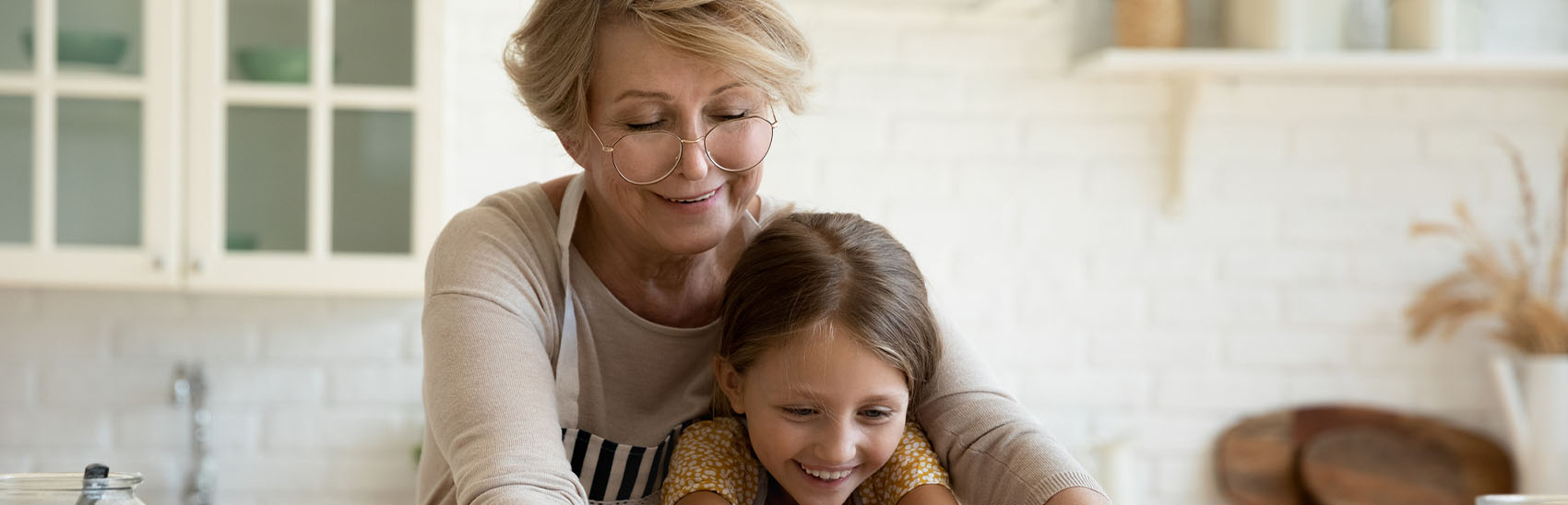 Senior woman with grandchild living pain-free, cooking and bonding