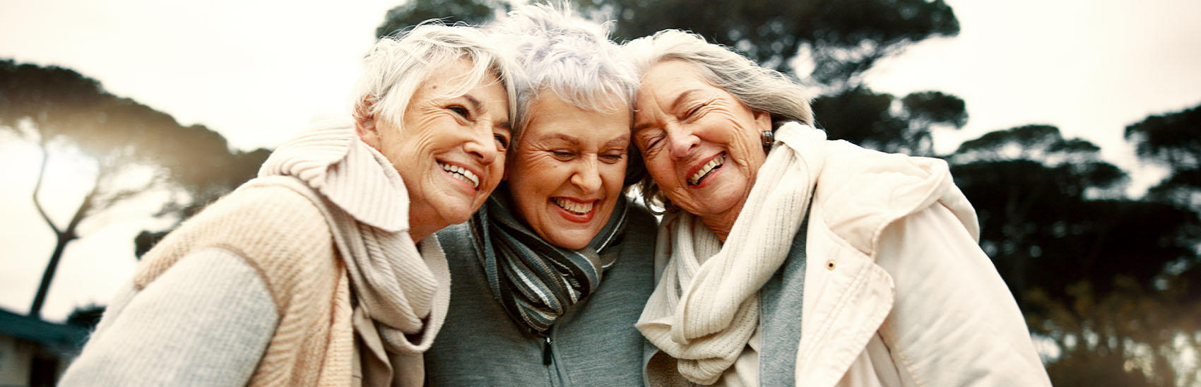 Three best friends smiling with hope in their eyes of their painless future.